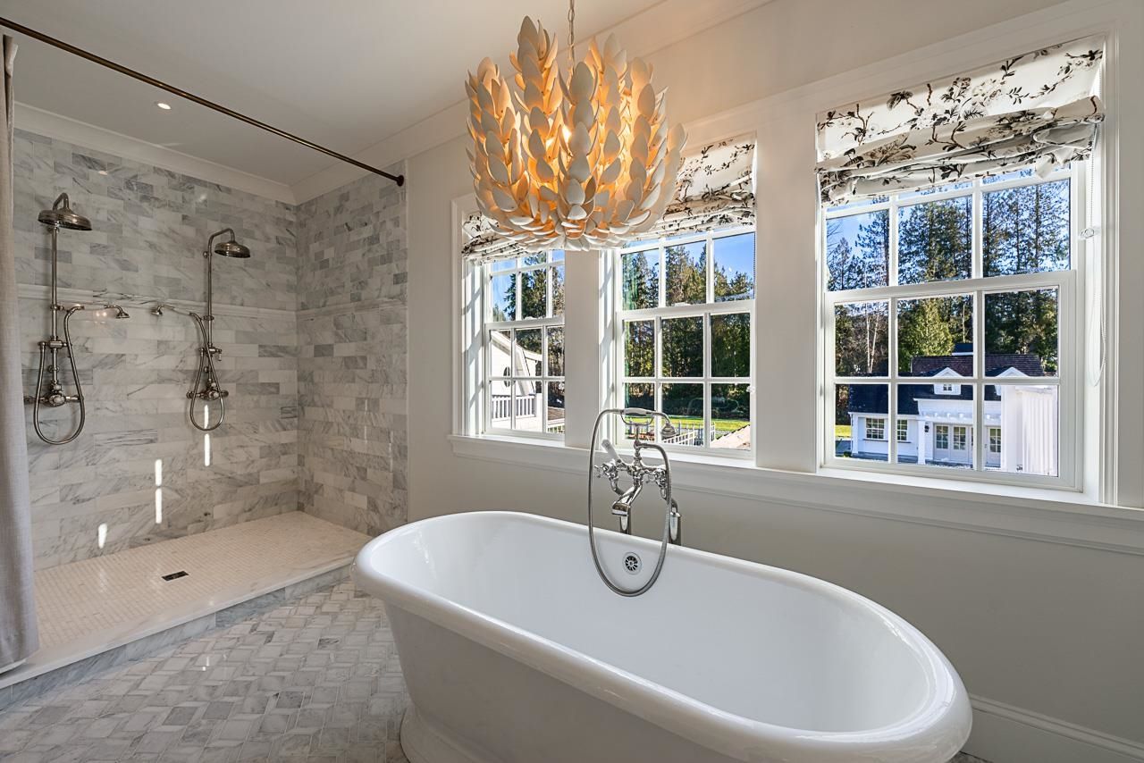 Grace Acres primary ensuite — freestanding soaker tub, marble shower, petal chandelier, Langley luxury home
