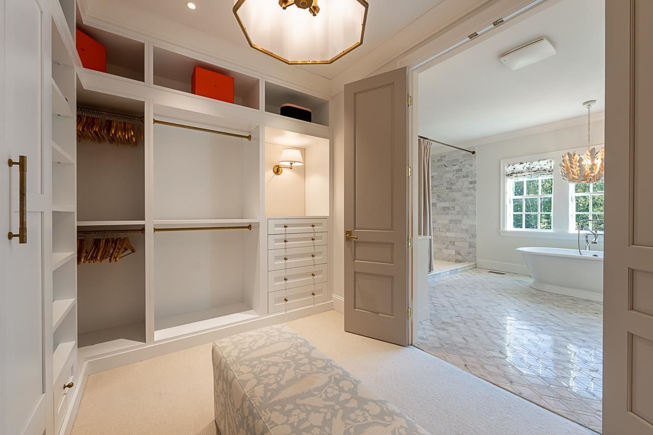 Grace Acres walk-in closet — custom built-ins, brass hardware, adjacent to ensuite