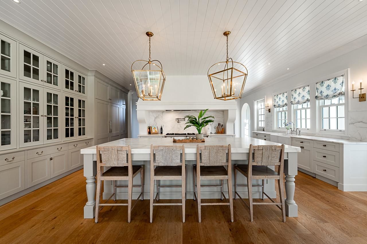 Grace Acres kitchen — marble island, brass pendants, shiplap ceiling, Langley luxury farmhouse