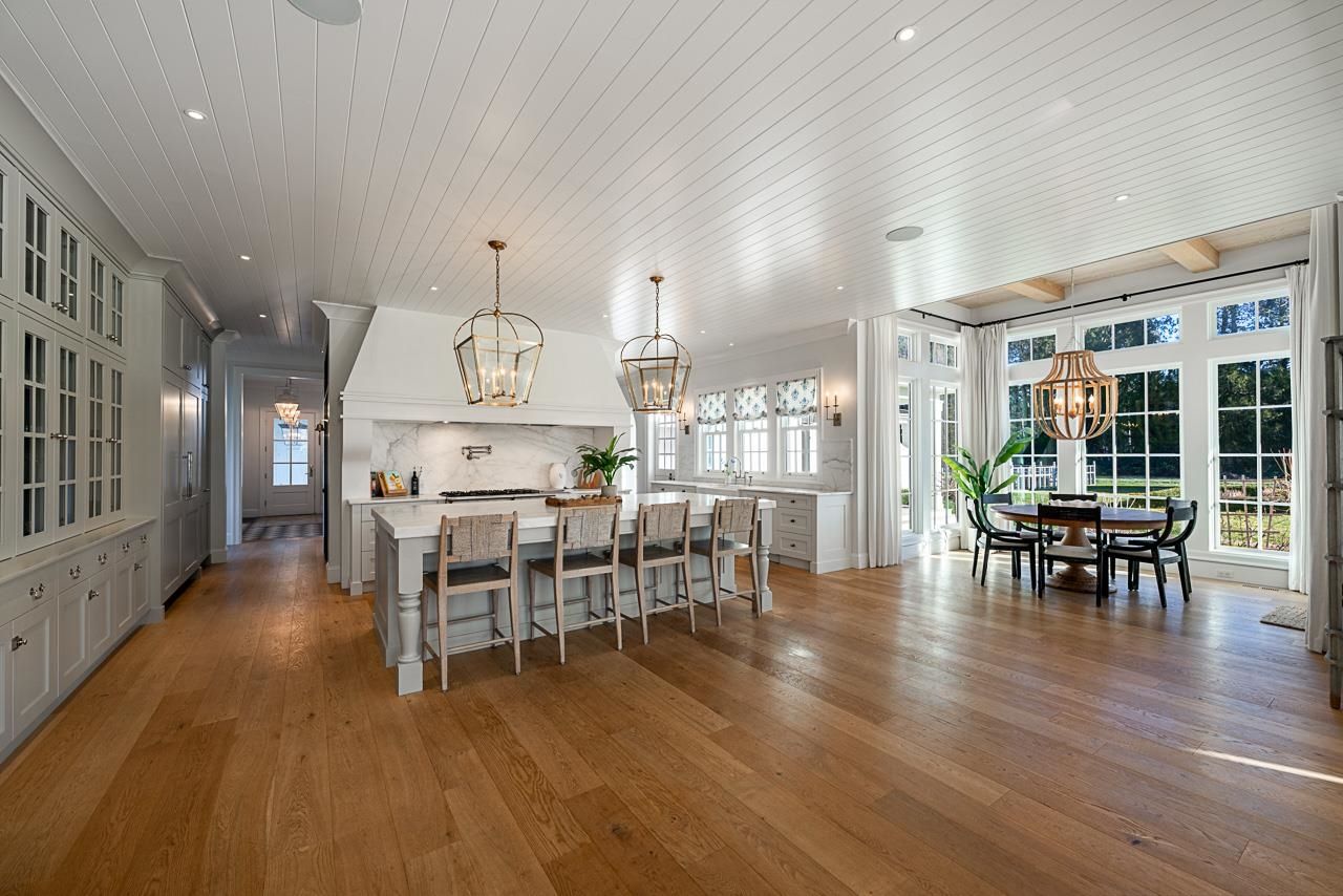 Grace Acres breakfast nook — floor to ceiling windows, exposed beam ceiling, French doors to grounds