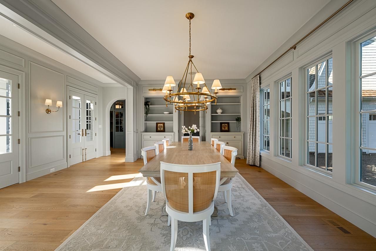 Grace Acres library — coffered ceiling, built-in shelves with rolling ladder, brass pendants