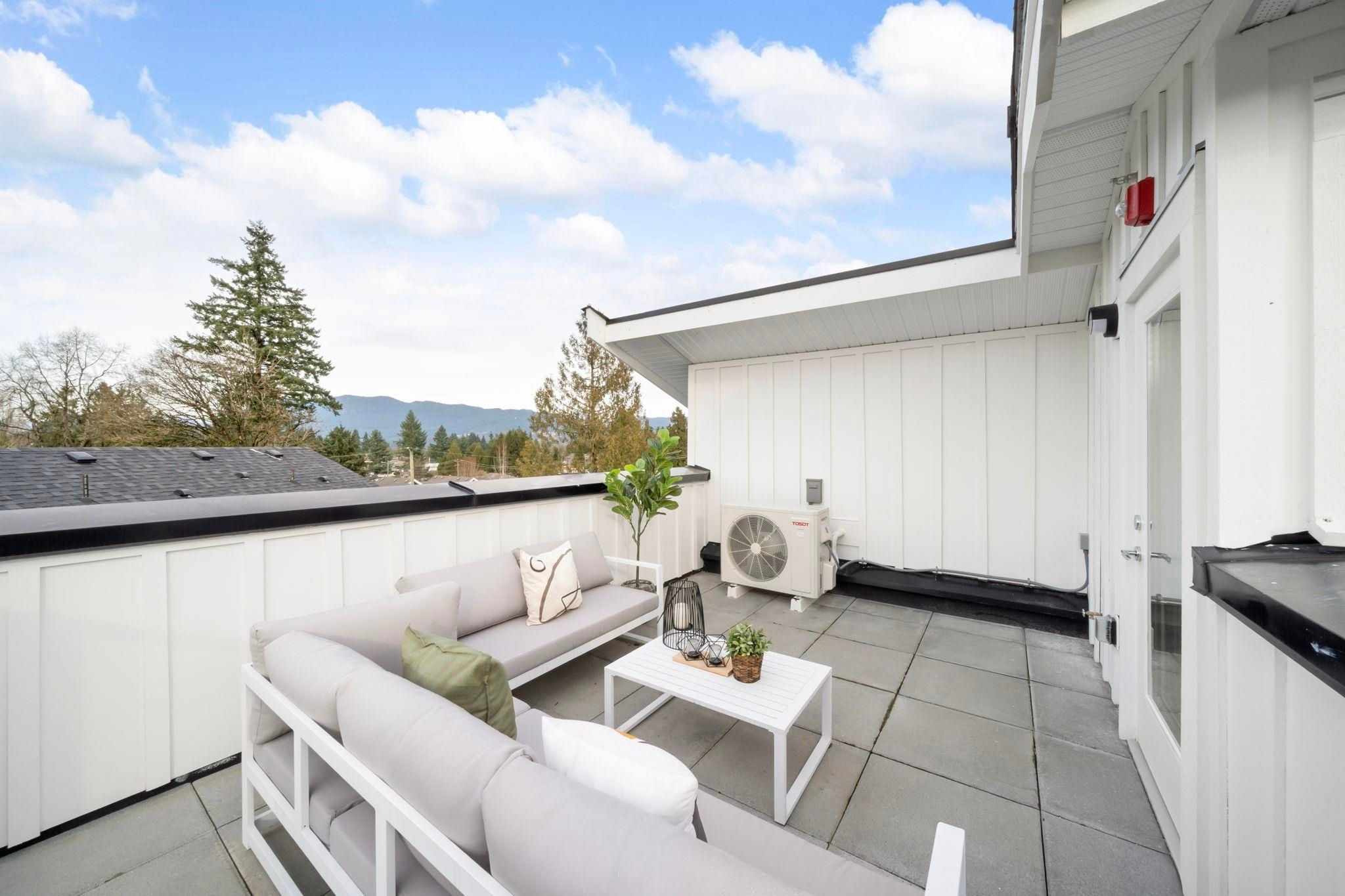 Second view of the rooftop patio at 6-728 Lea Avenue showing the full footprint and surrounding townhome rooftops