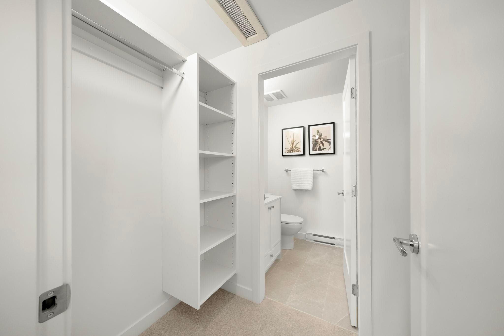 Walk-in closet off the primary bedroom at 6-728 Lea Avenue with built-in shelving