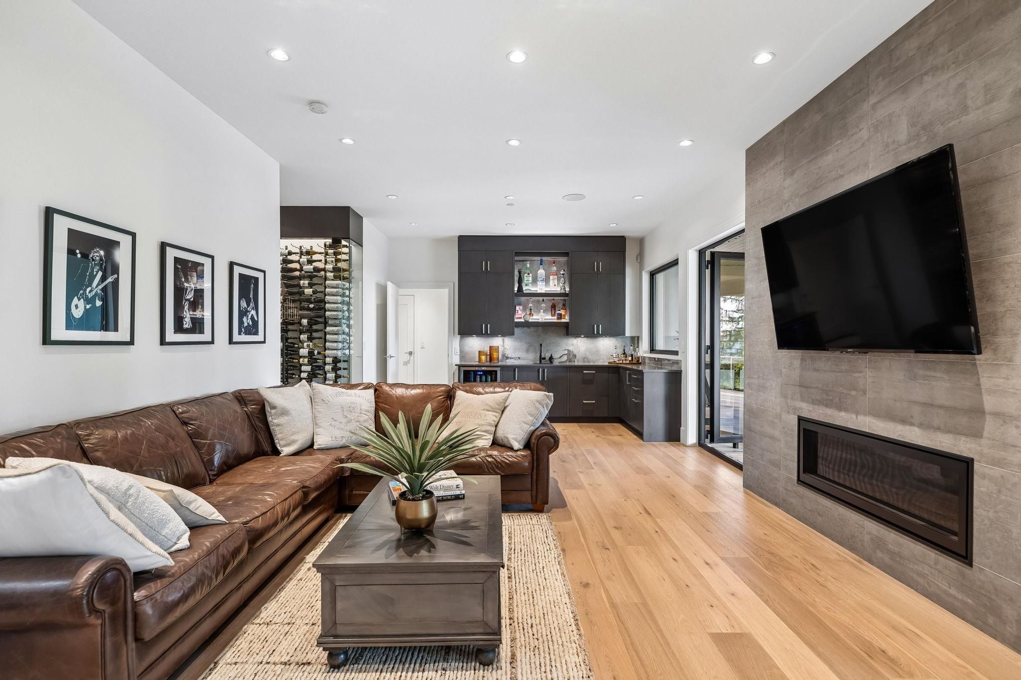 Basement bar room with television and seating at Anmore estate
