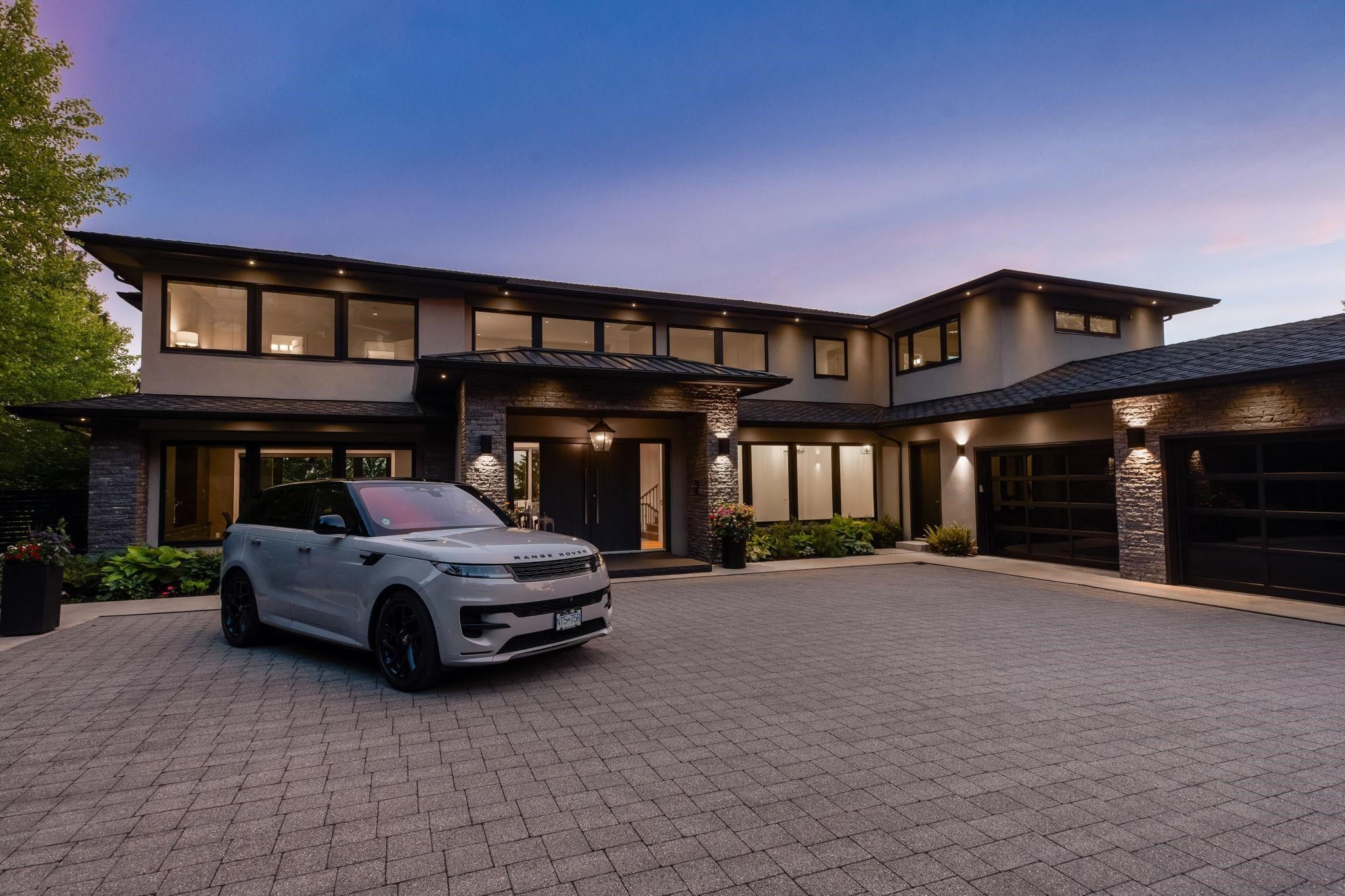 Modern two-storey luxury home exterior with pool at 2051 Ridge Mountain Drive in Anmore, backed by forest