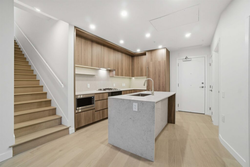 Kitchen in the Cambie Corridor sub-penthouse with Caesarstone countertops and Miele appliances