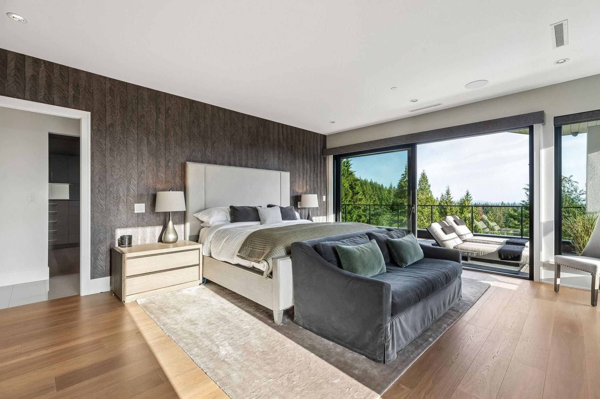 Primary bedroom with private balcony and forest view at 2051 Ridge Mountain Drive, Anmore