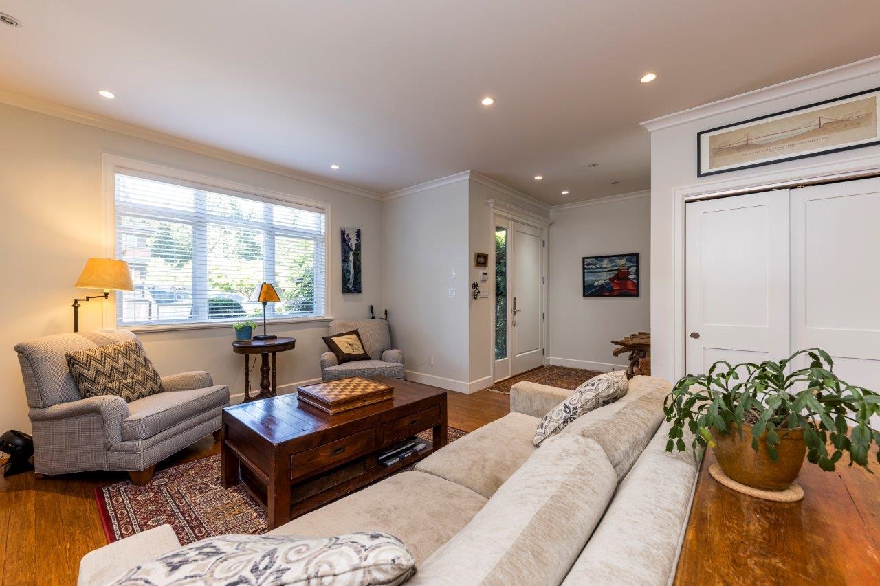 Living room at 1426 Draycott Road with wood-finish flooring, recessed lighting, and crown molding