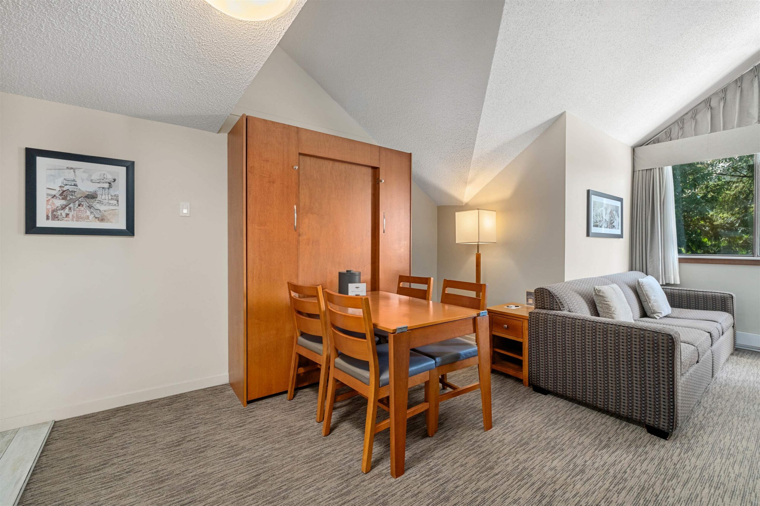 Dining nook with Murphy bed (folded up) and sofa, doubling as extra sleeping space when guests arrive
