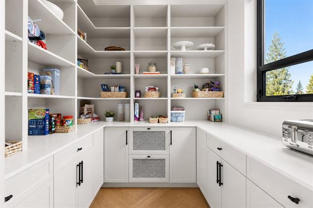 Butler's pantry with open shelving and built-in storage at 944 Caithness Crescent, Glenayre