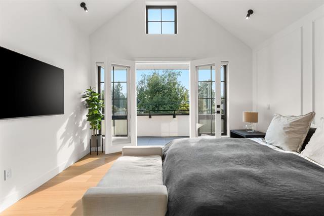 Primary bedroom with vaulted ceiling and private deck access at 944 Caithness Crescent, Glenayre