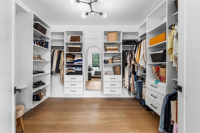 Oversized walk-in closet with custom built-ins at 944 Caithness Crescent, Glenayre
