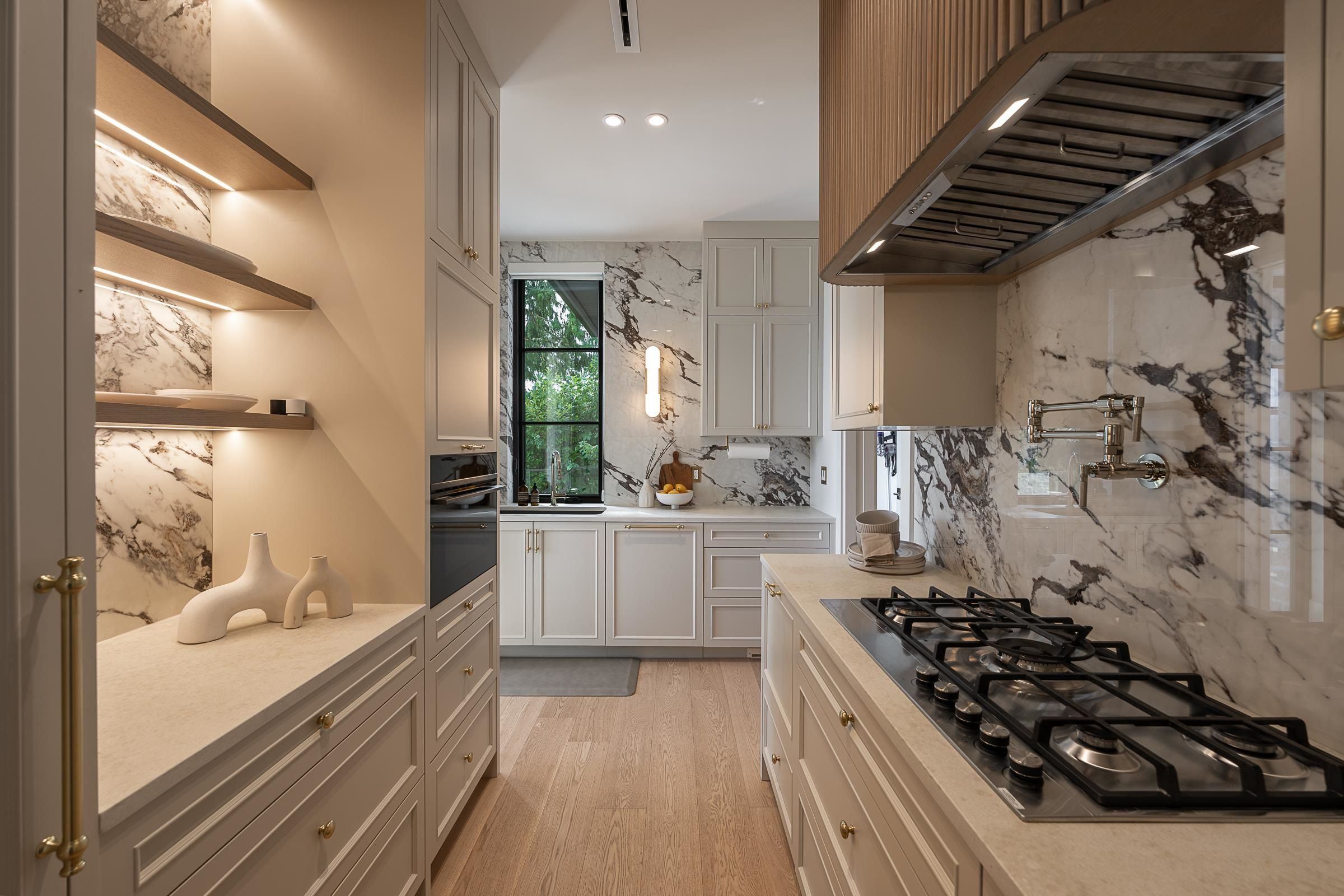 Butler's pantry with floating shelves and marble backsplash at 2976 Lazy A Street, Ranch Park