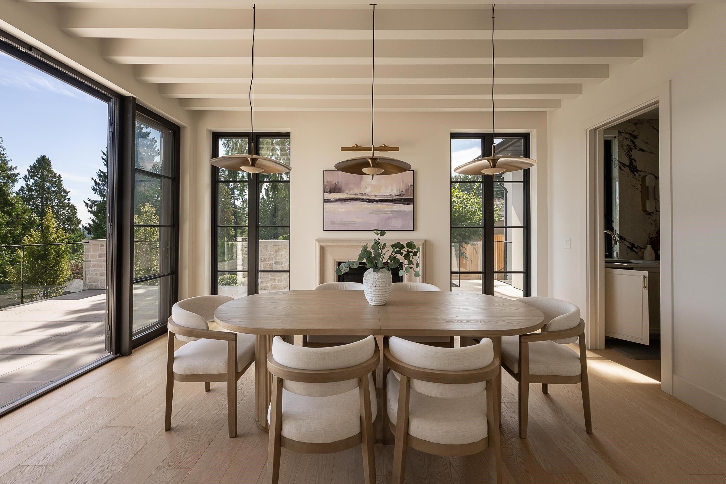 Dining room with beamed ceiling and corner fireplace opening to the patio at 2976 Lazy A Street