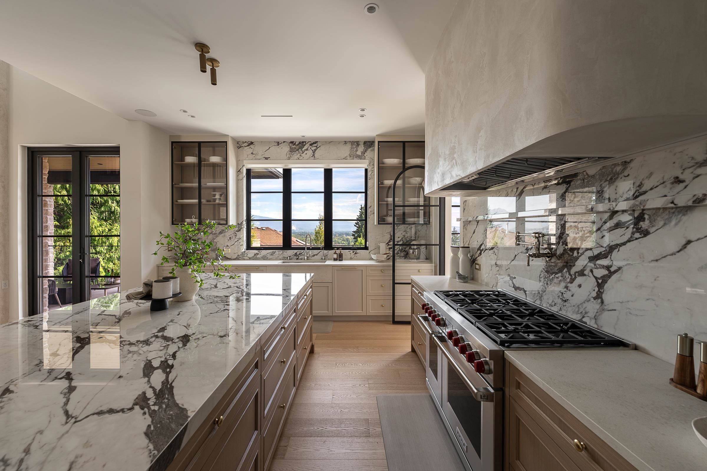 46-inch Wolf range with full slab marble backsplash and pot filler at Ranch Park custom home