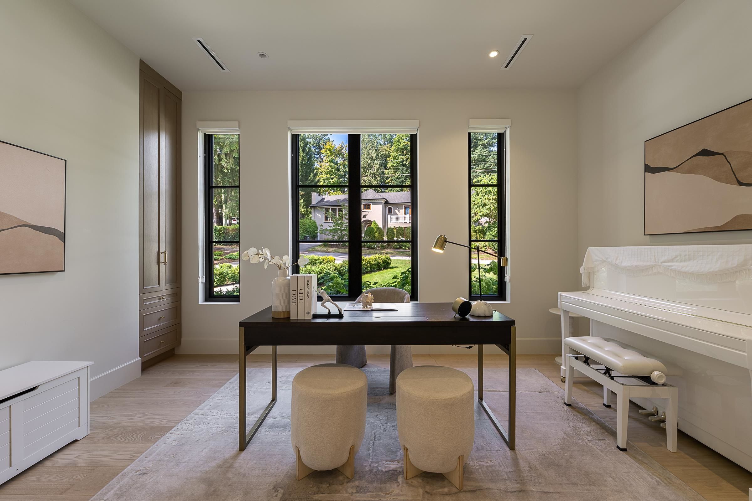 Main-floor home office with built-in desk and tall windows at 2976 Lazy A Street, Ranch Park