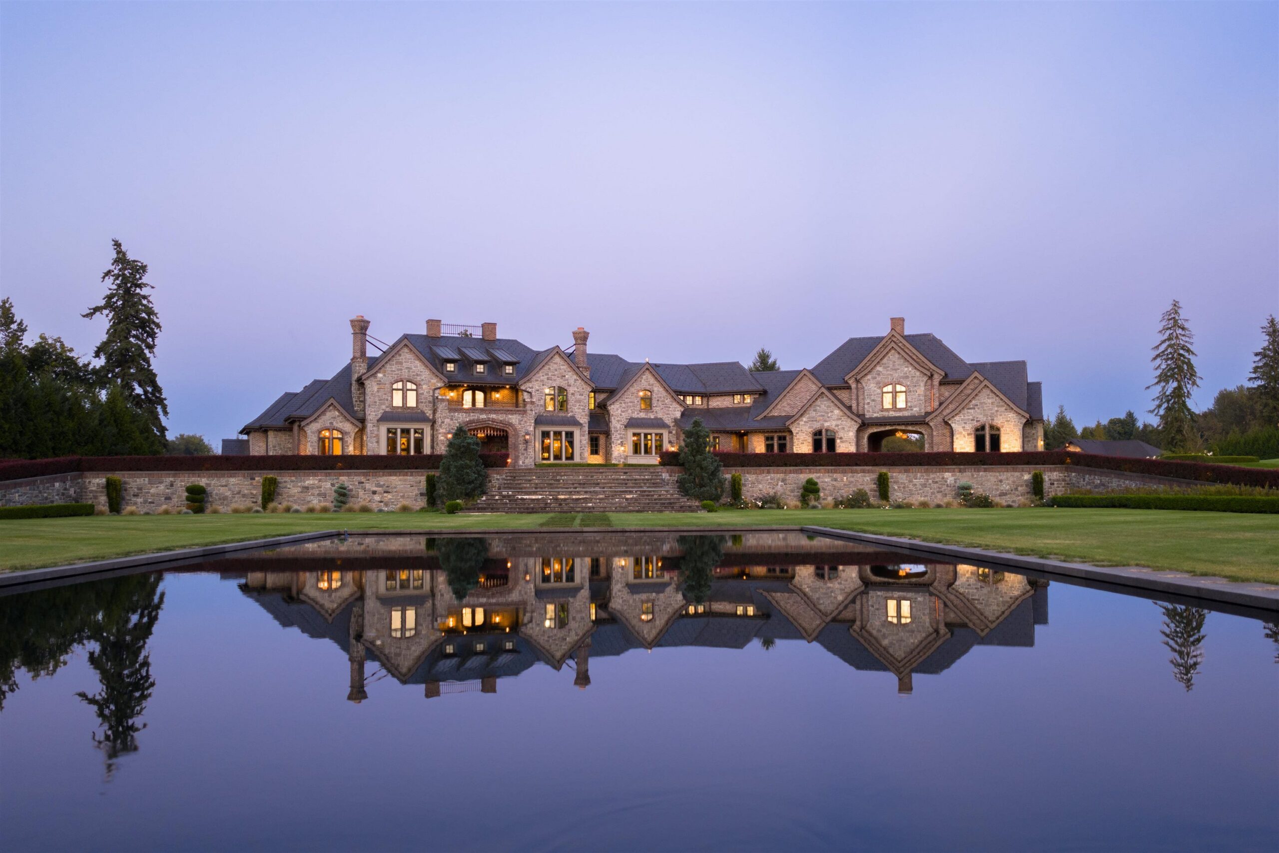 Tannin Manor main residence mirrored in the reflecting pool inside the front gates