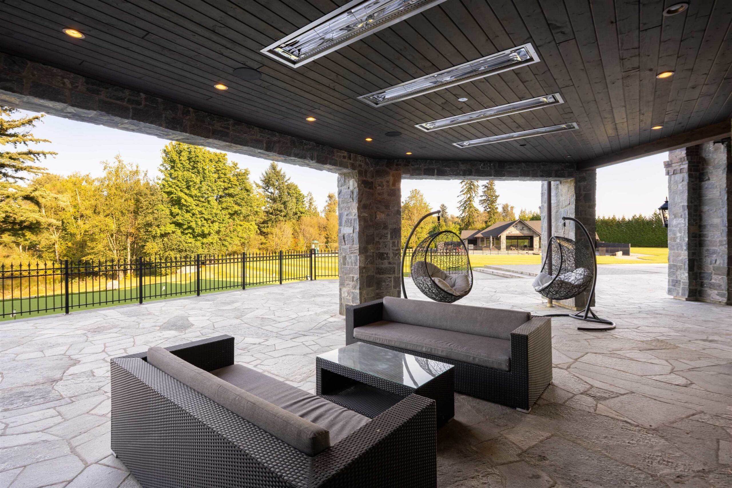 Covered stone patio with outdoor seating at Tannin Manor
